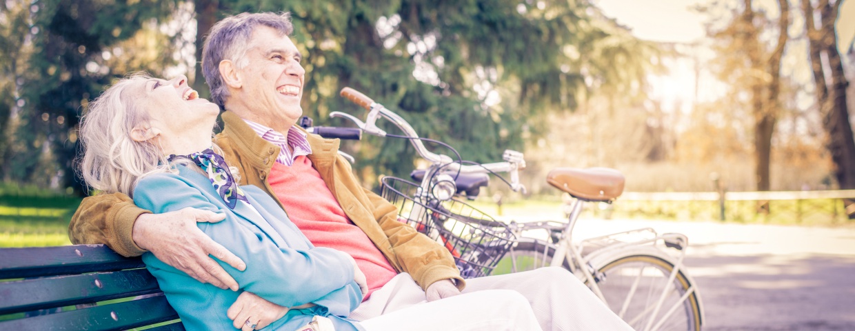 older couple sitting on park bench