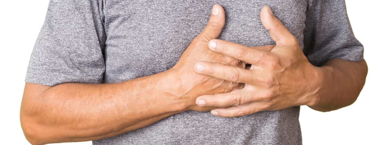 Close up of male patient holding chest, chest pain concept after surgery Close up of male patient holding chest, chest pain concept after surgery