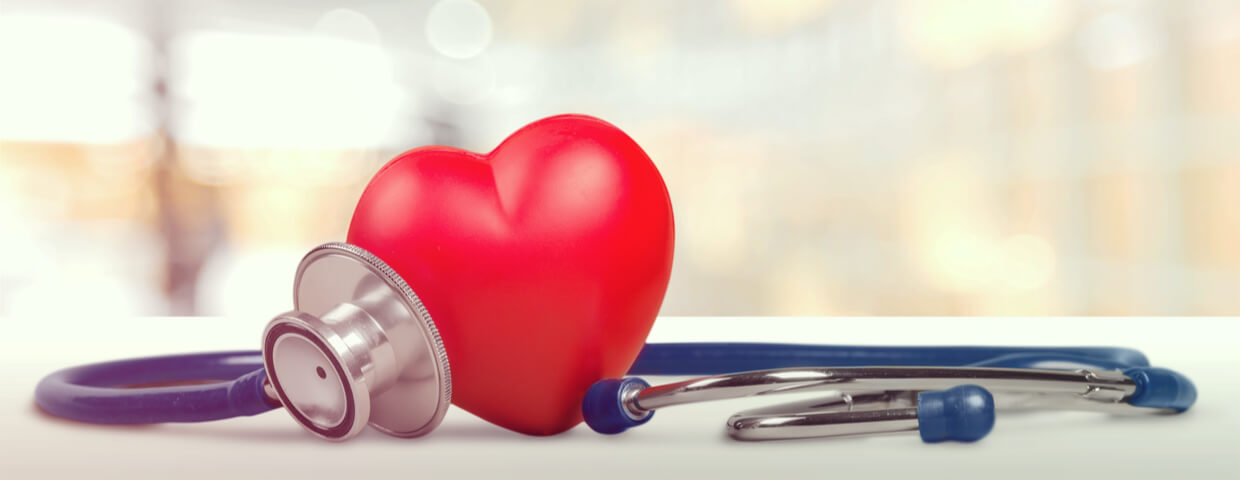 One red heart love shape hand exercise ball with medical doctor physician's stethoscope One red heart love shape hand exercise ball with medical doctor physician's stethoscope